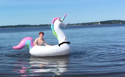 Keller with our Giant Rainbow Unicorn Pool float
